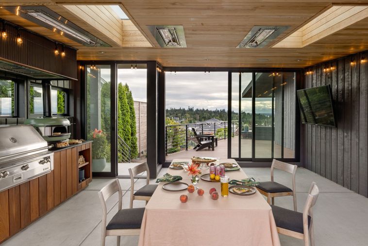 The ventilation fan over the Alfresco Grill ALXE is concealed by tile, chosen to meld with the painted cedar walls.