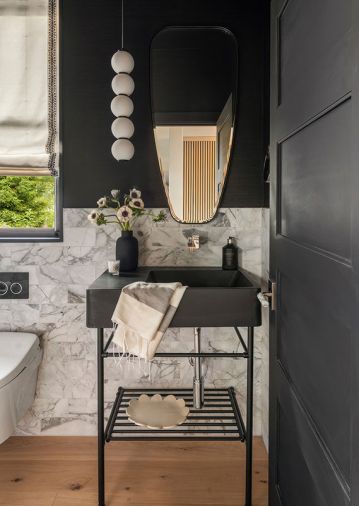 A floating vanity by Crystal Cabinetry with a Laminam counter packs plenty of storage with no visual clutter. An ExBrite LED mirror produces and reflects light while the creamy Walker Zanger wall tile and flooring is soft and neutral. All room elements work together to direct the gaze out through windows to the Puget Sound views, especially while soaking in the tub.