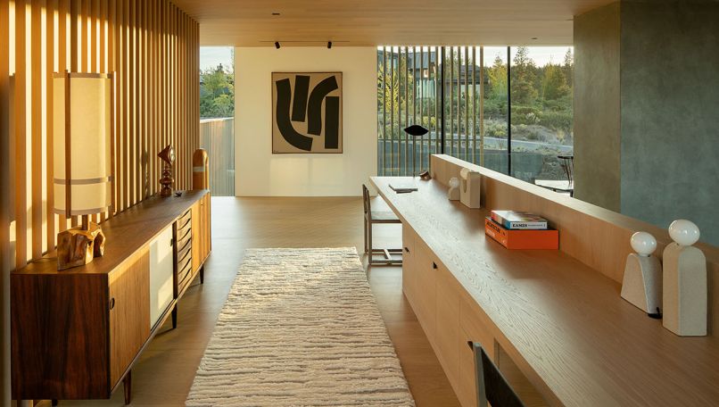 Upstairs, are his/hers custom desks by MADE, Inc., which parallels an Arne Vodder sideboard from 1stDibs. The Michele Russo artwork draws your eye to the view.