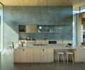 The BlueStar range is set in Euro Plastering’s “silver” wall and anchored in white oak casework. Michael Anastassiades chandeliers are found throughout.