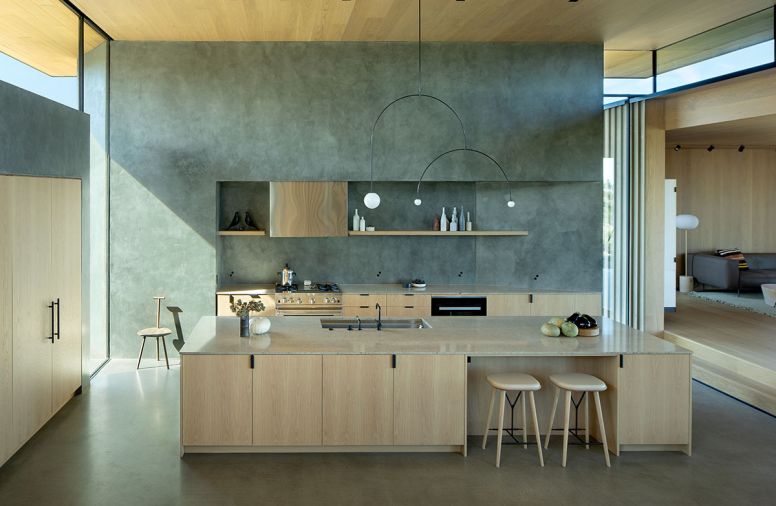 The BlueStar range is set in Euro Plastering’s “silver” wall and anchored in white oak casework. Michael Anastassiades chandeliers are found throughout.