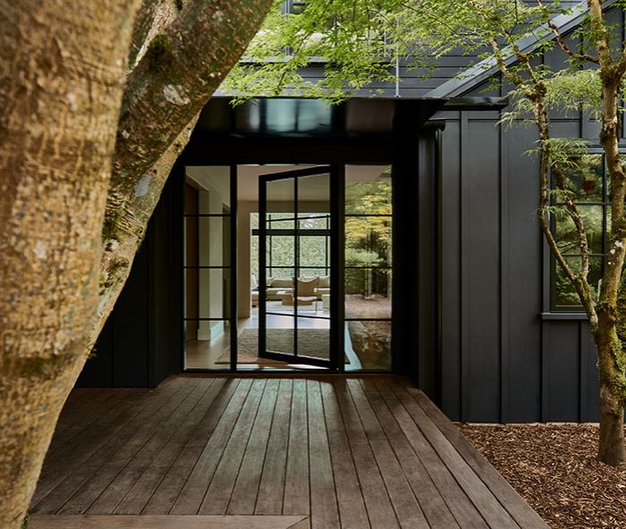 The modern aesthetic is set with board and batten exterior siding painted in Benjamin Moore “Onyx.” The black-framed windows and door by Marvin were sourced from Cherry Creek Windows & Doors.