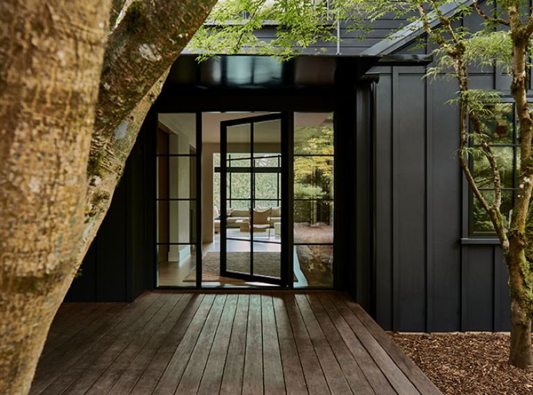 The modern aesthetic is set with board and batten exterior siding painted in Benjamin Moore “Onyx.” The black-framed windows and door by Marvin were sourced from Cherry Creek Windows & Doors.