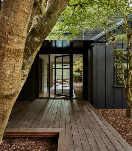 The modern aesthetic is set with board and batten exterior siding painted in Benjamin Moore “Onyx.” The black-framed windows and door by Marvin were sourced from Cherry Creek Windows & Doors.
