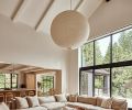 A custom sectional from Couch Seattle surrounds a bespoke table from Montello Design. The Noguchi lantern utilizes traditional Japanese materials to bring modern design to the home.