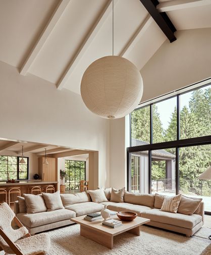 A custom sectional from Couch Seattle surrounds a bespoke table from Montello Design. The Noguchi lantern utilizes traditional Japanese materials to bring modern design to the home.