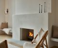 The Portola limewash on the surrounding walls and clean lines of the fireplace create a calm environment in the living room. A Kofod-Larsen Knitting Chair sits nearby.