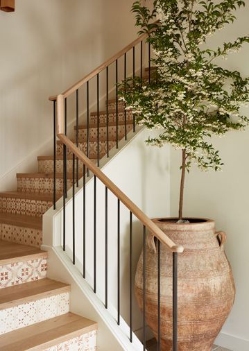 European white oak plank treads from Montello Design with custom handrails and balusters are jaunty. The tile by Tabarka Studio via Ann Sacks on the staircase bring a soft sophistication to each step.
