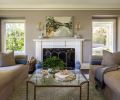 In the living room, a coffee table designed by Nifelle Design and built by Culver Glass and Emmerling Ironworks sits with Andante Plain Recamiers from Kravet.