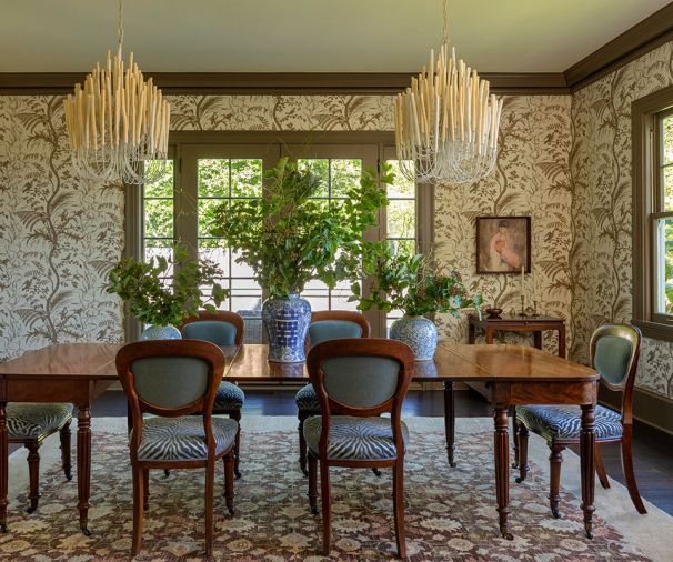Tilda Chandeliers from Arteriors and recovered antique chairs are the stars in the dining room. The Benjamin Moore paint is custom color-matched to the Brunschwig & Fils wallpaper.