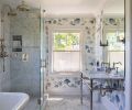 Leonard added “Weeping Pine” wallcovering in “Slate” from Schumacher to sync with the existing tile in the primary bathroom.