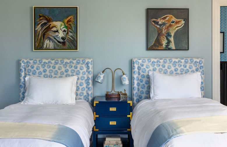 The headboards are upholstered in Firecrackers “Sky” from Schumacher. They are paired with Benjamin Moore “Wickham Gray” on the walls, a Tansu 2-Drawer from Bungalow 5, and a Thomas O’Brien lamp with matching custom lampshades.