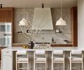 Anchored in natural materiality, the kitchen is awash in warm colors and organic textures. Custom cabinetry is plain-sawn white oak by Rockwood Cabinetry. Maiden Home counter stools and Newport Brass plumbing fixtures add sophistication, texture and shine.