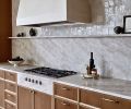 Quartzite in ‘Taj Mahal’ sets the tone for the kitchen. The undulating stone aprons the integrated cooktop and beautifully frames the Gagganau range from Standard TV & Appliance.