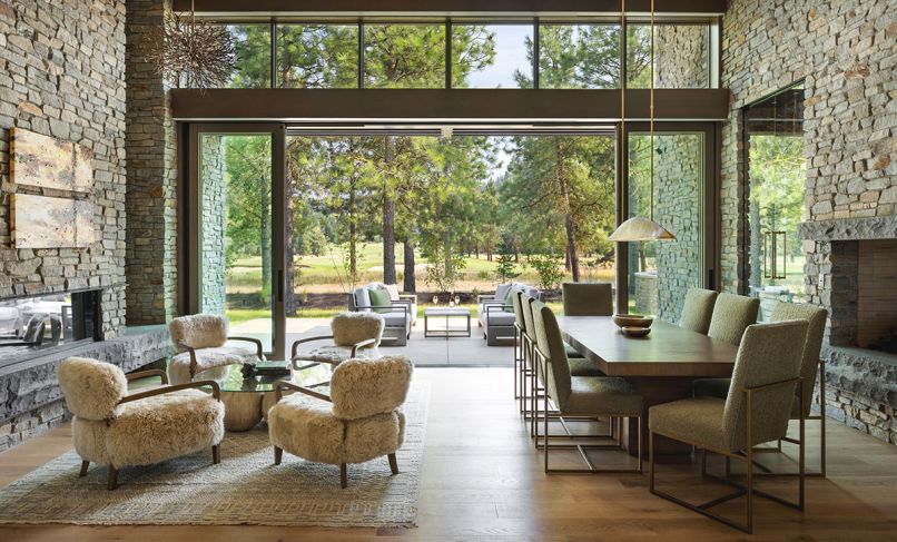 Neutral-toned furnishings and natural building materials including fir beams, limestone, and bronze touches welcome through lift and slide stacking, aluminum clad doors in the living and family rooms.