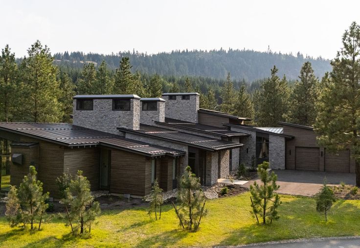 On the exterior, Hewn Elements cedar select tight knot siding, Connecticut Blend Ledgestone, and metal roof panels in dark bronze from Taylor Metal Products, all ensure the home blends in with the site that overlooks the golf course.