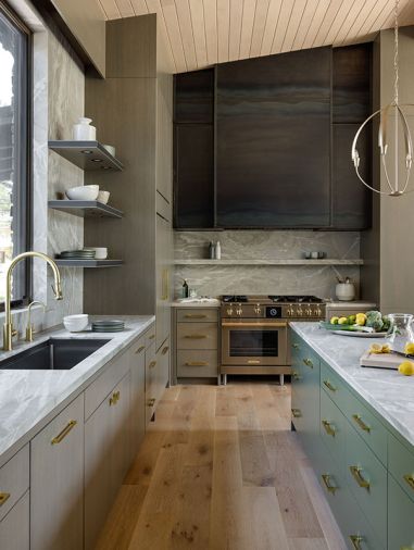 The island is painted in “Jade Romanesque” by Benjamin Moore, and adorned with handles from New York Hardware. The hood vent is oiled metal adding a rustic industrial touch.