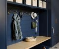 In the mudroom, the custom cabinetry features slide out baskets for elegant storage. The Northwest Custom Interiors cabinetry is painted “Hale Navy” from Benjamin Moore.