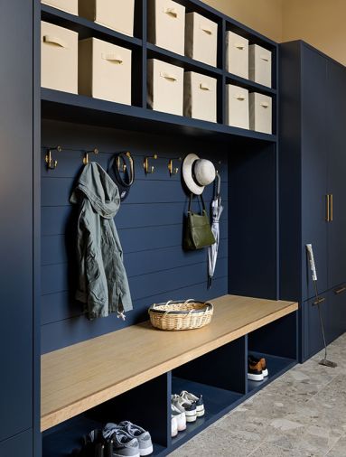 In the mudroom, the custom cabinetry features slide out baskets for elegant storage. The Northwest Custom Interiors cabinetry is painted “Hale Navy” from Benjamin Moore.