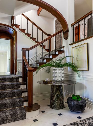 Leonard combined an Elegante Firefly Marble Table from Baker with a charcoal hand-knotted rug from Capel Rugs on the existing tile floor.