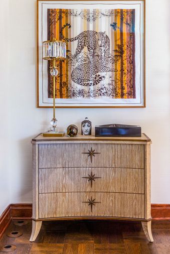 Nifelle Design framed a Hermes silk scarf and placed it with an American white oak credenza.