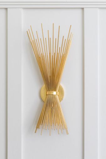 Also in the library, the brass Strada Small Sconce from Visual Comfort provides a cozy glow and ties with similar lighting fixtures in the new bathroom.