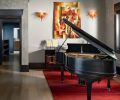 The doorway is custom Venetian plaster by Level 5, and the Caracole buffet lines the wall in a piano finish. Artwork includes custom lighting by artist Ed Pennebaker from Red Fern Glass.