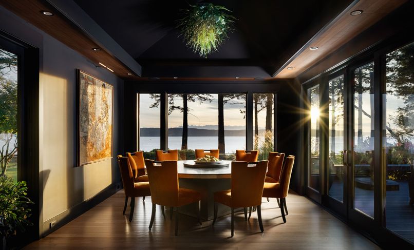 The dining room comes alive with sunshine flooding in from the floor-to-ceiling windows. This allows for the color “Graphite” from Benjamin Moore to give a moody vibe as it joins the rich walnut soffit. Throughout the home, the team worked with Pella Windows & Doors to repurpose and add new windows and doors.