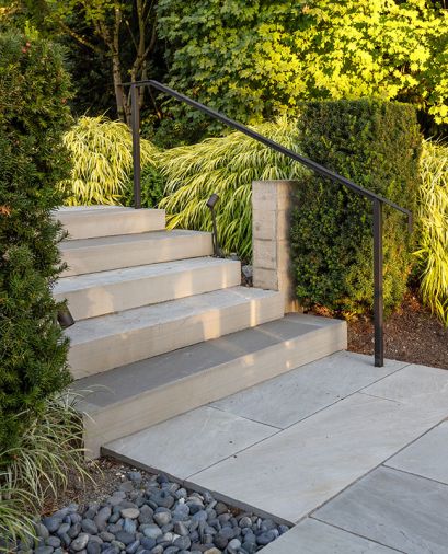Holsapple created this secret little passageway for guests to arrive at the patio gathering place shielded from the driveway by Mondo Grass, Vine Maple and Eddie Yew.