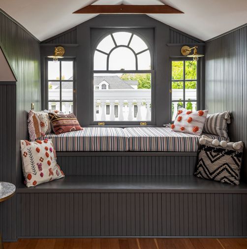 A day bed does double duty, providing a cozy place to curl up while hiding ducting for the new forced air system.