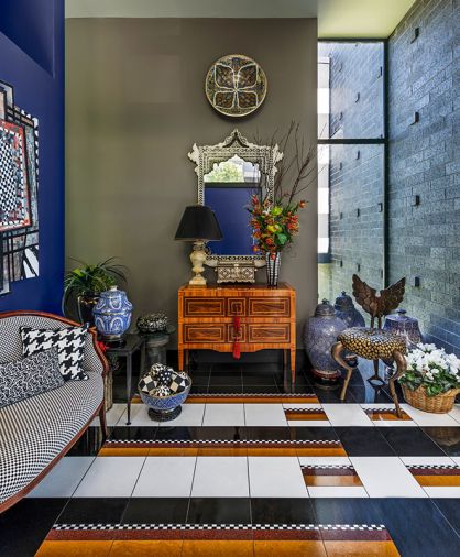 Guests are greeted in the entryway by the Angel Chair from Mark Brazier-Jones and an Edwardian upholstered sofa in Alexander Girard&rsquo;s Checkered for Maharam. Paired with Walker Zanger&rsquo;s Tribeca checkered flooring from Bedrosians, the motif is thoughtfully echoed throughout the home.
