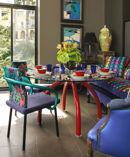 Dining in the garden room includes Mandarin table and chairs by Ettore Sottsass and Schroeder&rsquo;s triptych Journey in Argentina. Porcelain tile lines the floor, sourced from United Tile.