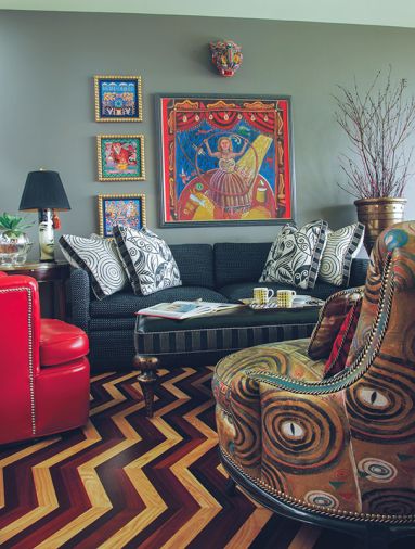 The Library features a Lina Cavalieri table lamp by Fornasetti, and a pair of Kravet red vinyl upholstered 1940's chairs.