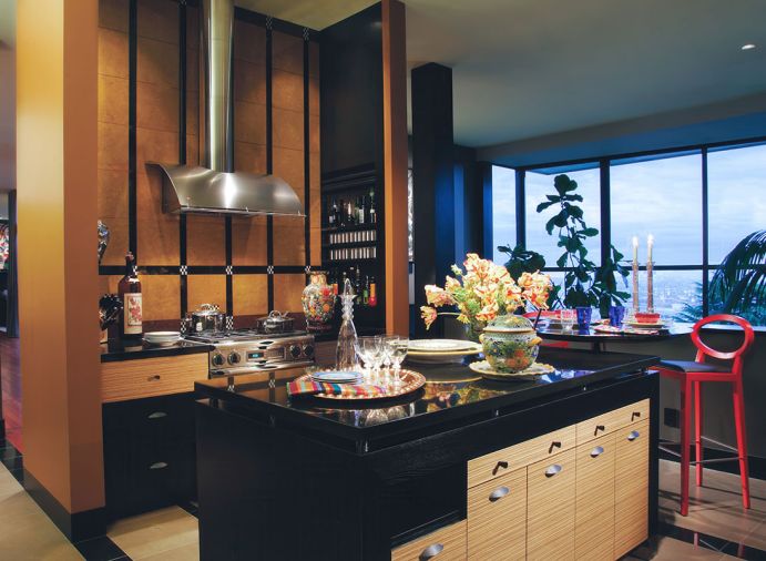 The kitchen features custom cabinetry by L & Z Specialties, Inc. paired with a porcelain tile floor with contrasting black granite details, installed by Campbell&rsquo;s Tile Concepts.
