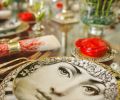 Porcelain-Rosenthal created the Architectural Fornasetti dinnerware that dresses the table. The beautiful face of 19th century opera singer Lina Cavalieri, popularized by a French magazine, was recreated by Italian artist Piero Fornasetti.