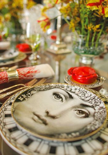 Porcelain-Rosenthal created the Architectural Fornasetti dinnerware that dresses the table. The beautiful face of 19th century opera singer Lina Cavalieri, popularized by a French magazine, was recreated by Italian artist Piero Fornasetti.