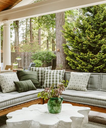 A Serena & Lily sectional sofa encourages luscious lounging against Humphrey&rsquo;s Sunbrella textile collection of pillows. A unique resin table invites feet up for fun.