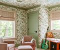 For an immersive experience, Humphrey wallpapered the guest room&rsquo;s walls and ceiling in a Lake August &ldquo;Nasturtium&rdquo; floral paper, bringing outside in. The homeowners suggested painting trim and window casing in different colors. The A. Rudin chairs are upholstered in corduroy velvet.