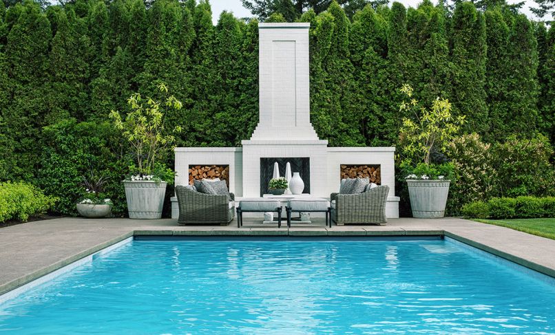 The magnificent pool makeover includes Refine Landscape Architecture&rsquo;s towering chimney design, paired with dual log storage areas set against the company&rsquo;s all new landscaping.