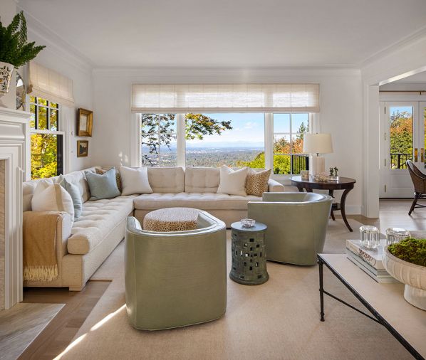 Now with a newly revealed view to the West, the living room houses a custom sofa with Scalamandre fabric and two custom leather chairs. Victoria Hagan sheers frame the window and a lush carpet encourages bare feet and cozy family times.