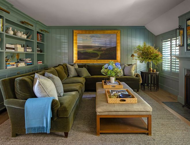 The family room is enrobed with the homeowner&rsquo;s favorite shade of green, &ldquo;GC655' from Fine Paints of Europe. A peaceful 1911 Harold Flos painting glows against the wall color. The custom sectional and ottomans were sourced through Maison, Inc.