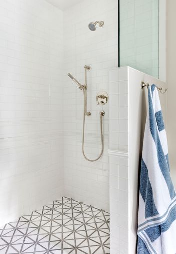 Two is better than one when it comes to tile. In the pool house shower, Simon chose a small-scale tile from Daltile and a gray-and-white geometric tile from Floor & Decor for the floors.