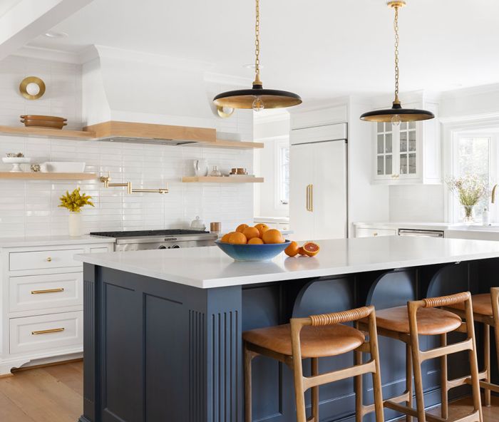 Instead of a crisp white, a soft, slightly warm hue, Benjamin Moore&rsquo;s &ldquo;Swiss Coffee&rdquo;, sets a neutral stage for Rejuvenation hardware and an island bathed in &ldquo;Stonecutter&rdquo;, a saturated teal.