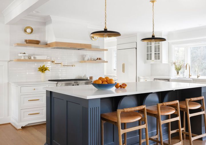 Instead of a crisp white, a soft, slightly warm hue, Benjamin Moore&rsquo;s &ldquo;Swiss Coffee&rdquo;, sets a neutral stage for Rejuvenation hardware and an island bathed in &ldquo;Stonecutter&rdquo;, a saturated teal.