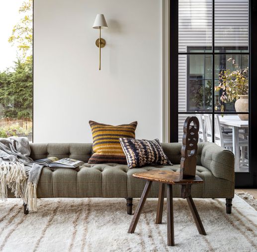 A John Derian Company Inc. sofa in Holland & Sherry plaid sits with a velvet sofa from Jayson Home.