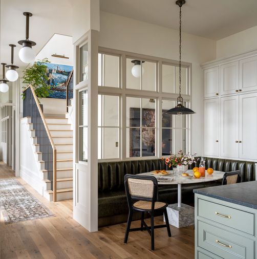 In a corner of the kitchen; the custom-designed Calacutta marble table, cabinetry fabricated by Interior Environments, and the leather banquette was constructed by HM Duke Design.