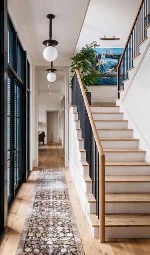 Throughout the house, there is white oak plank flooring from Montello Design (formerly Eurocraft Hardwood Floors). At the stair landing, the painting by Ethan Murrow was sourced through Winston W&auml;chter Fine Art.