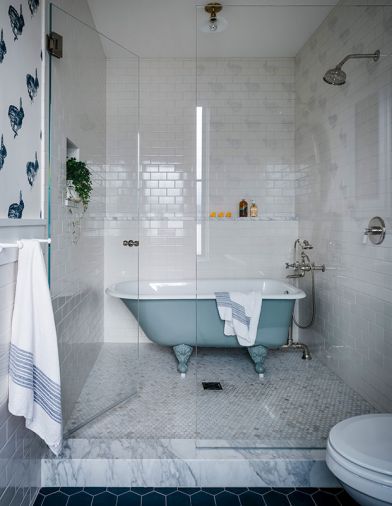 The nursery&rsquo;s en-suite bathroom, is set with subway tiles from Pratt & Larson and a &ldquo;Bun&rdquo; wallcovering by Lake August. Combining the clawfoot tub with the walk-in shower saved space in the compact footprint.