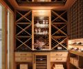 In the welcoming wine room, all the rift-cut white oak storage is by Northwest Custom Interiors, with Tanner&rsquo;s Craft leather and bronze hardware, and an antiqued mirror backsplash.