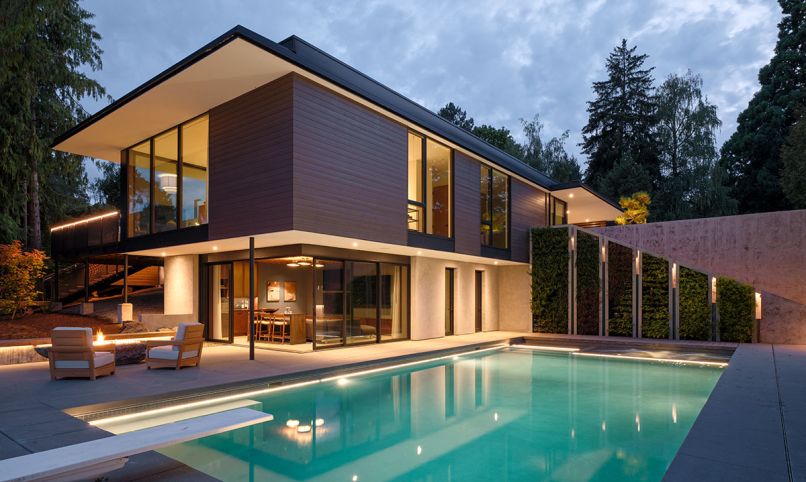 The pool courtyard links the guest house with the main residence. The pool and hot tub, sourced through PoolPro, Inc., is a welcoming gathering area for the family.